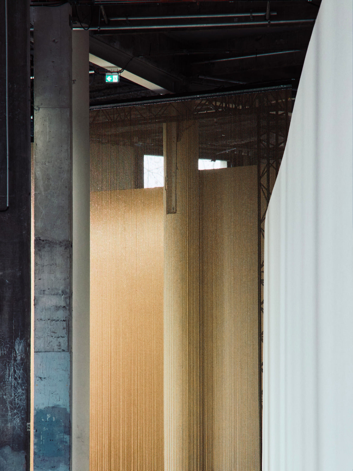 A collection of textile samples featuring shimmering gold sequins, intricate metallic weaves, and a delicate white fabric with a subtle checkered pattern.