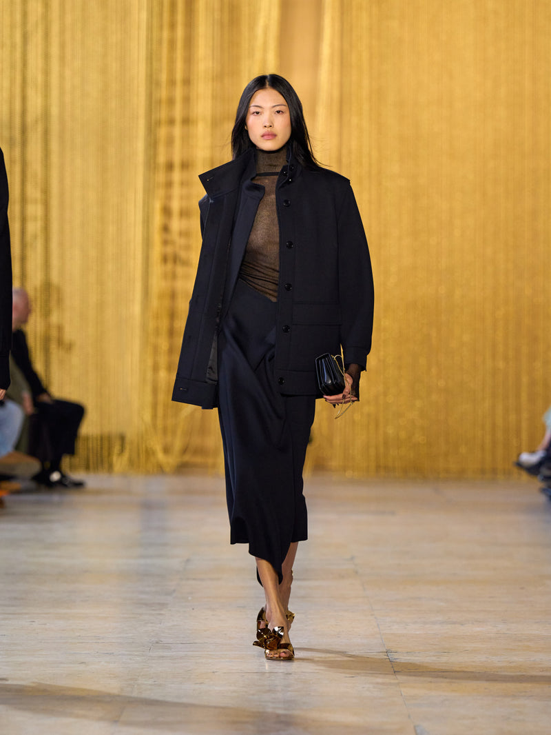 A tribute to Olga de Amaral in the Akris FW26 collection in Paris, defined by a dialogue between deep blacks, burgundy, and metallic gold accents