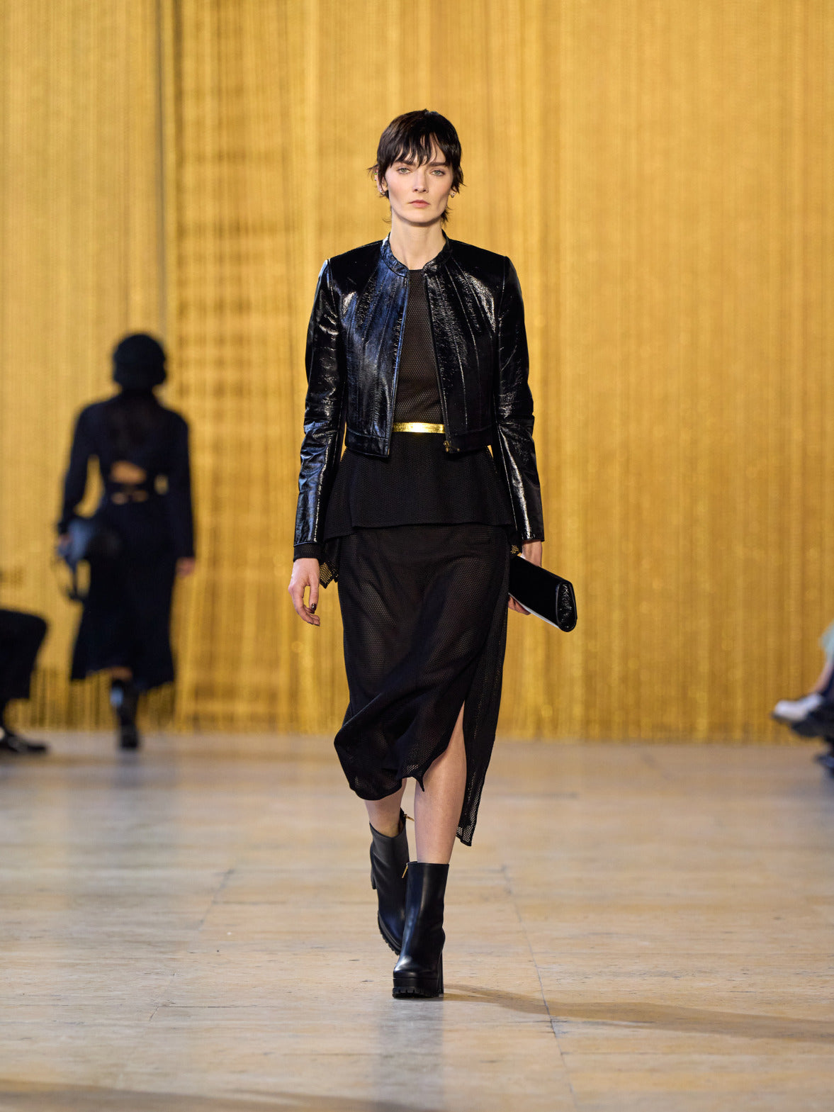 A tribute to Olga de Amaral in the Akris FW26 collection in Paris, defined by a dialogue between deep blacks, burgundy, and metallic gold accents