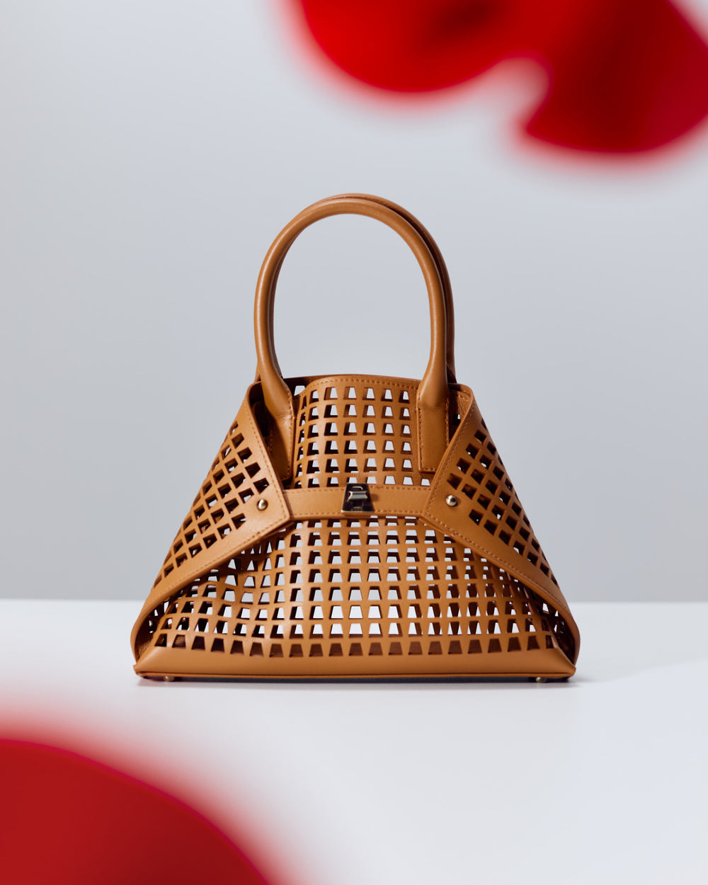 New Bag Accessories in Lasercut trapezoid from Akris.
