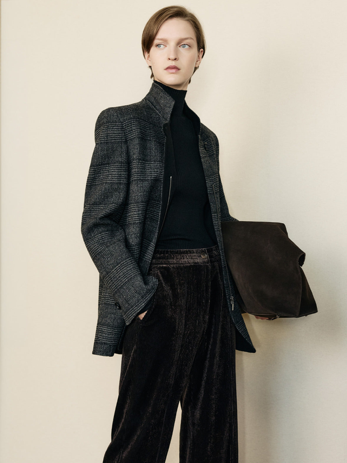 Look from the Akris punto Fall 2026 collection featuring a tailored check jacket, fluid velvet trousers and understated layering with contemporary everyday elegance.
