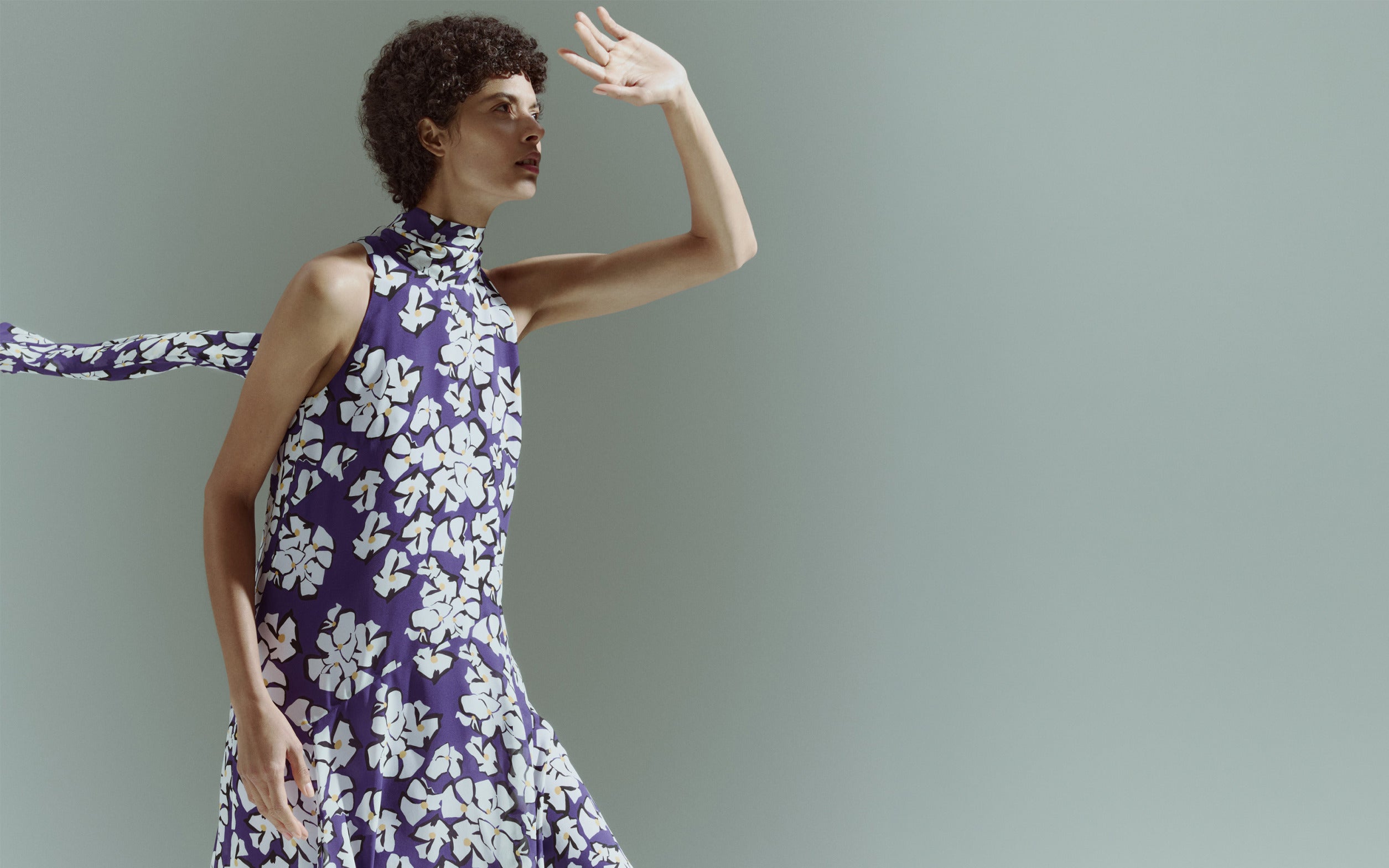 Model wearing a sleeveless high-neck top with a purple and white floral print from the Akris punto Pre-Fall 2026 collection.