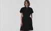 Akris punto Spring video showcasing a black mini dress with an animated polka dot effect. The focus is on the magical appearance of white dots on the black fabric, highlighting the brand’s signature playful and graphic aesthetic.